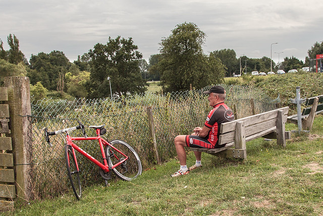Cyclist taking a rest and smoking a cigarette