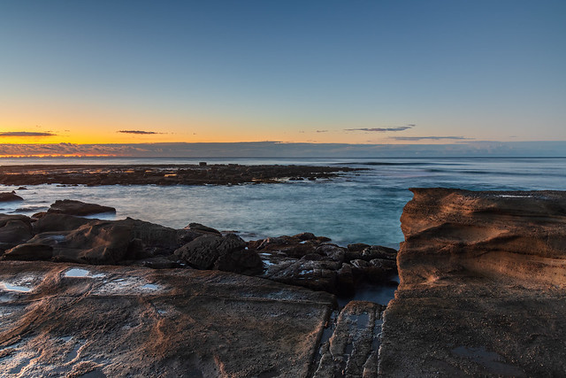 Sunrise seascape with rock platform