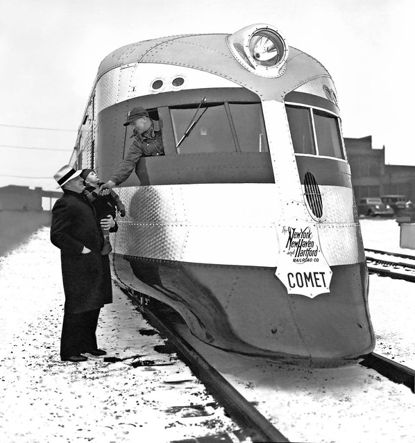 New Haven Railroad Winter snow scene with the three car Comet train set and a young visitor receiving an up close first hand view and a handshake from the engineer, ca late 1930's