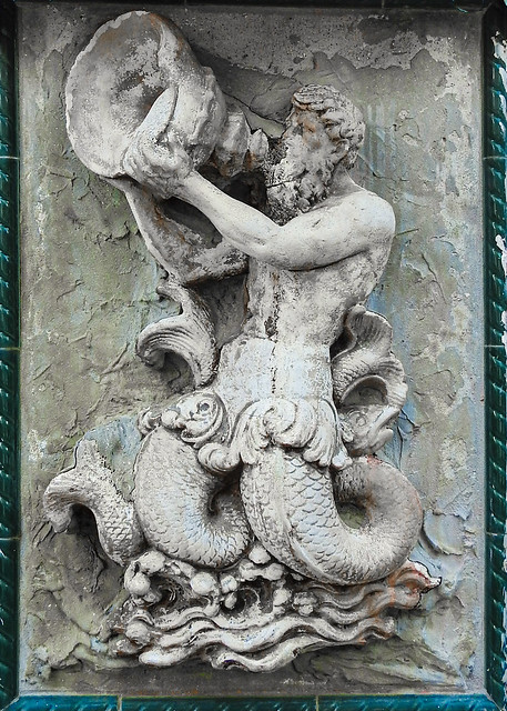 old damaged low relief sculpture / Triton