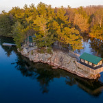 A Cozy Cottage in the Heart of Thousand Islands Perched in the Canadian wilderness, amidst the rugged beauty of the Thousand Islands, a cantilevered cottage serves as an oasis of tranquility. The aerial perspective captured by photographer Duncan Rawlinson offers a breathtaking view of this solitary retreat, delicately poised between sky and water.

The glass-like calm of the surrounding waters mirrors the unblemished heavens, instilling a sense of the cottage hovering in an infinite expanse between two realms. The vibrant palette of the verdant foliage offsets the earthen tones of the cottage, creating a striking tableau of nature&#039;s raw beauty and the modest simplicity of rural architecture.

The serenity of the scene is tangible, the still waters whispering tales of peaceful solitude. The cottage, though isolated, offers a compelling portrayal of idyllic lakeside living. It is not mere remoteness, but an eloquent testimony to the blissful calm that a retreat into nature can offer.

Duncan Rawlinson&#039;s photographic acumen is evident as he encapsulates the rustic charm and quiet allure of cottage living, amidst the untamed splendor of the Thousand Islands. This frame not only offers a glimpse into a secluded paradise but also highlights the undeniable magic that lies in Ontario&#039;s picturesque landscapes.


&lt;a href=&quot;https://Duncan.co/a-cozy-cottage-in-the-heart-of-thousand-islands&quot; rel=&quot;noreferrer nofollow&quot;&gt;Duncan.co/a-cozy-cottage-in-the-heart-of-thousand-islands&lt;/a&gt;