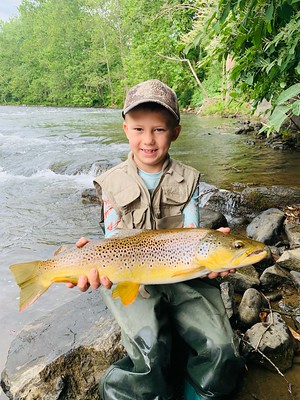 Photo of young man holding a large trout