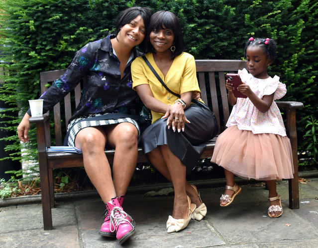 DSC_2124a Alesha Jamaican Model and Tricia from Ghana in Black Leather Skirt and Mustard Top with Her Beautiful Daughter in Pink Dress on Location at John Wesley Methodist Chapel Churchyard City Road London