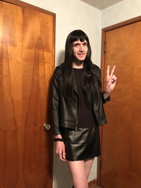 crossdresser in all black outfit with faux leather jacket and faux leather miniskirt~