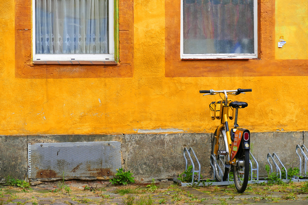 Yellow bike orange wall