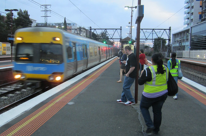 Comeng train arriving at South Yarra as patronage survey staff wait on the platform