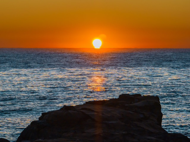 Sunrise over the ocean with orange horizon
