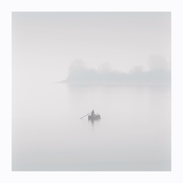 A lone fisherman in foggy lake Kerkini, Greece