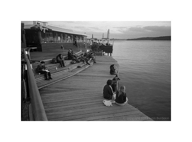 Relaxing on Manly pier in the twilight. Sydney harbour, winter 2023  #725-