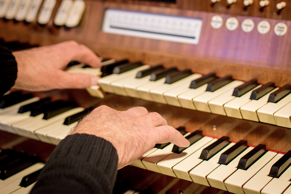 organist practicing - practice skills of expert musicians
