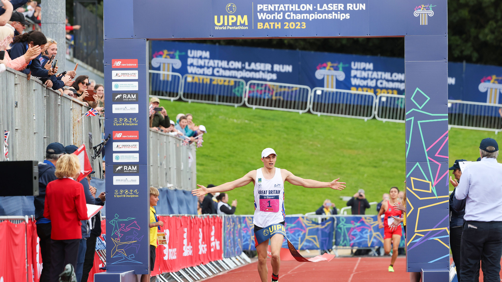 A picture of Joe Choong crossing the finish line in the men's final at the UIPM Pentathlon World Championships 2023