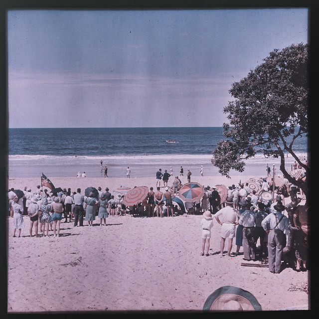 Crowds of people on a Gold Coast beach in the 1940s