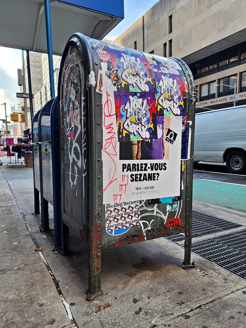 Mailbox covered with graffiti and stickers on 7th Avenue