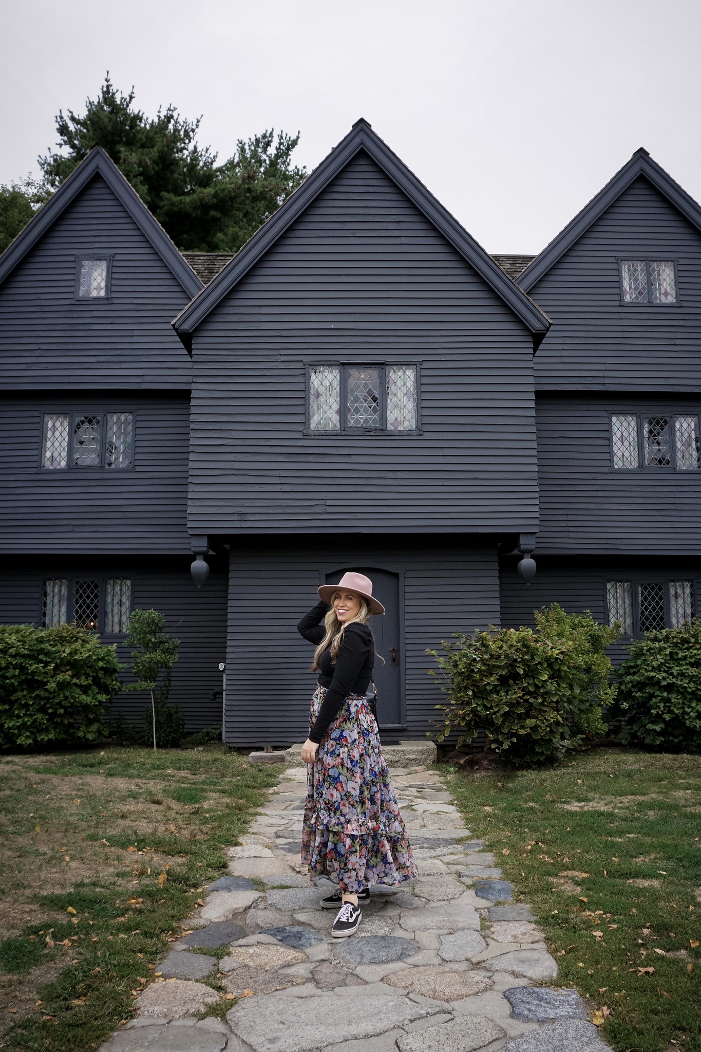 Girl standing in front of The Witch House in Salem Massachusetts