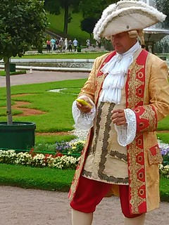 Anachronism: A costumed man in St Petersburg checking his cellphone
