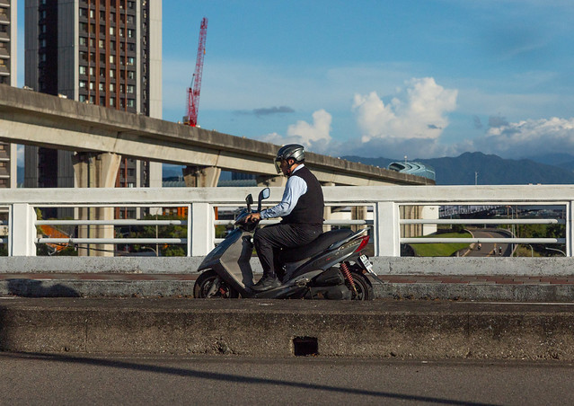 Man riding a scooter on a highway, Taipei, Taipei, Taiwan