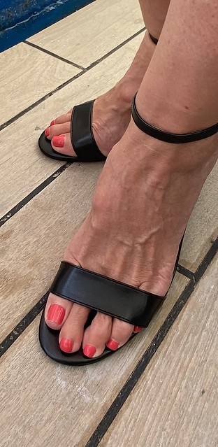 Long sexy painted toes in a strappy sandal.