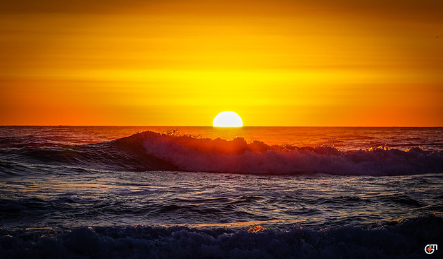 Sunset behind the waves