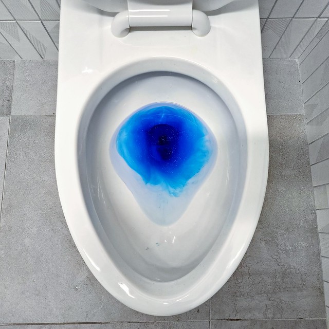 Blue tablet in toilet