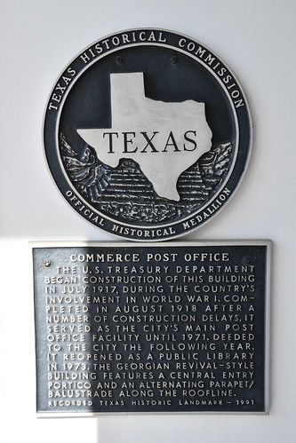 Old Post Office (Commerce, Texas) Historical marker for the U.S. Post Office in Commerce, Texas.  The plaque states:

Commerce Post Office - The U. S. Treasury Department began construction of this building in July 1917, during the country&#039;s involvement in World War I. Completed in August 1918 after a number of construction delays, it served as the city&#039;s main post office facility until 1971. Deeded to the city the following year, it reopened as a public library in 1973. The Georgian Revival-style building features a central entry portico and an alternating parapet/balustrade along the roofline. Recorded Texas Historic Landmark - 1991