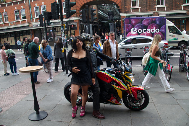 DSC_2611 Spitalfields London Commercial Street 2016 Red & Gold Honda Jazz SE I-Vtec 1318 cc Motorcycle MM16UML Rider with Lion Mask and Alesha Jamaican Model in Black Dress on Location