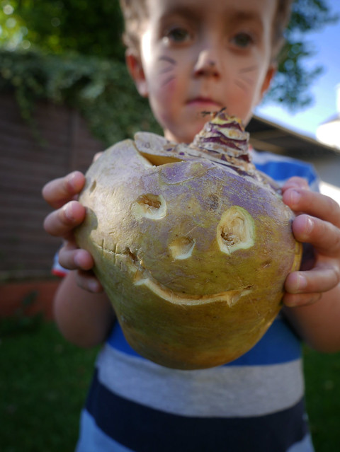 Young boy shows off his Hop tu Naa turnip lantern