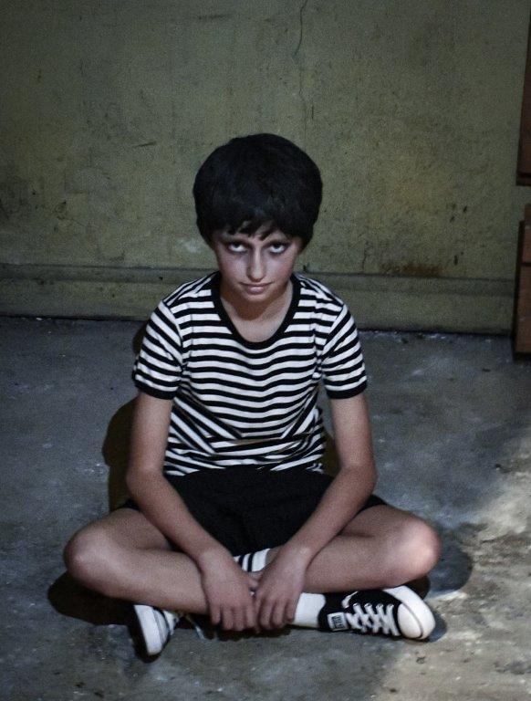 Pugsley Addams (Emma Froeschle) waits for his sister in the mansion’s basement.