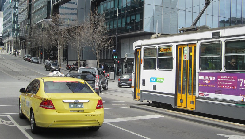 Tram waiting for right-turning cars in Collins Street, Docklands, 2013