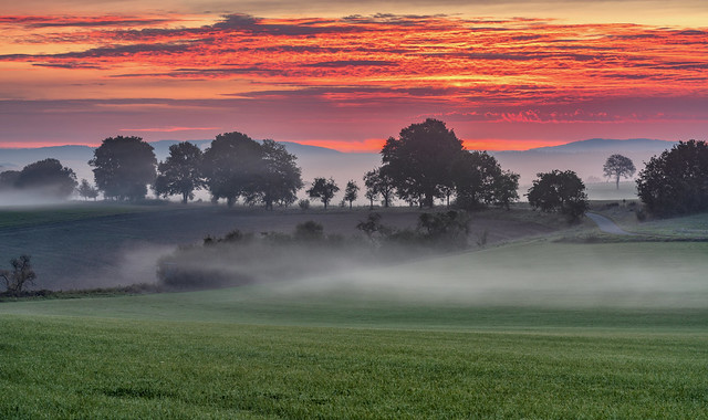 *burning morning sky over the misty valley*