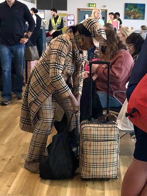 Female passenger obsessed with Burberry, Birmingham Airport, England
