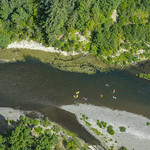 Colorful kayakers paddle in the Clackamas River. Colorful kayakers paddle in the Clackamas River.