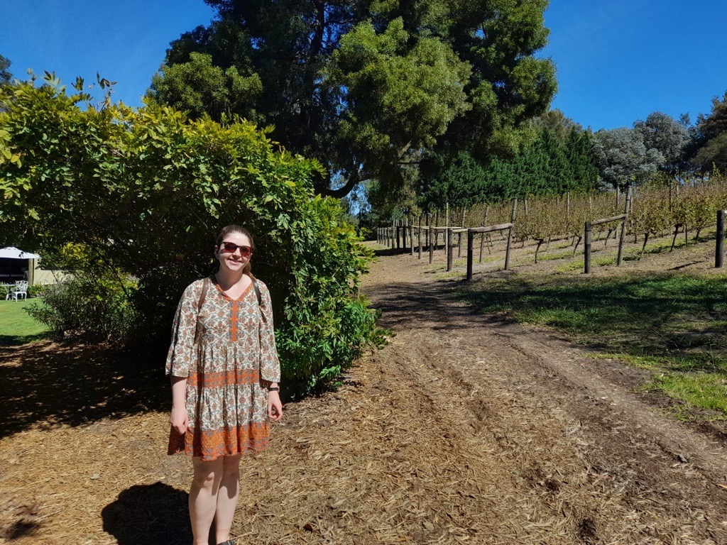 Bethan standing in front of a vineyard.