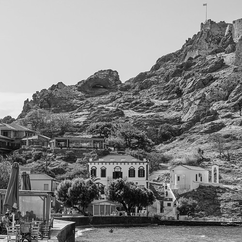 The View Along Romeiko Gialos Seafront Area of Myrina Town on Lemnos with the Castle & Agia Paraskevi Church (Monochrome) (OM-1 & 12-100mm F4 Pro Lens)