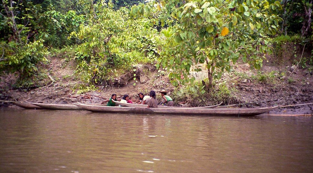 Women in dugout canoes; trip from trail from Sekalio back to coast, Siberut, Mentawai Islands, Sumatra, Indonesia
