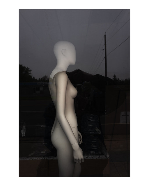 Female mannequin in unopend boutique