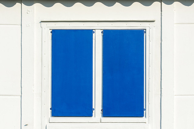 Beach hut with two blue shutters