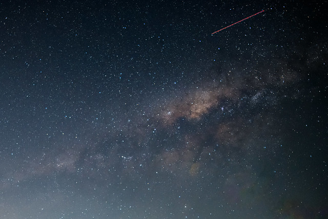 The Milky Way Galaxy and an aircraft path in the sky