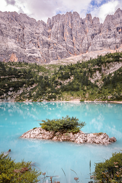Overgrown Rock in the turquoise Mountain Lake