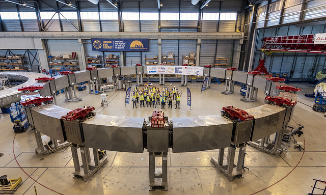 Representatives of F4E, ASG, ISQ, Dalkia, Veolia, Onet standing in the middle of Poloidal Field coil 4, manufactured by Europe in the PF coils factory, Cadarache, July 2023. ©F4E