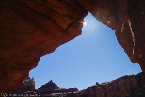 A sun star in Trail Arch above Peek-a-boo Camp, Needles District of Canyonlands National Park, Utah
