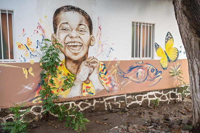 Painting of a smiling young boy on a building in Tarrafal - Santiago island - Cape Verde