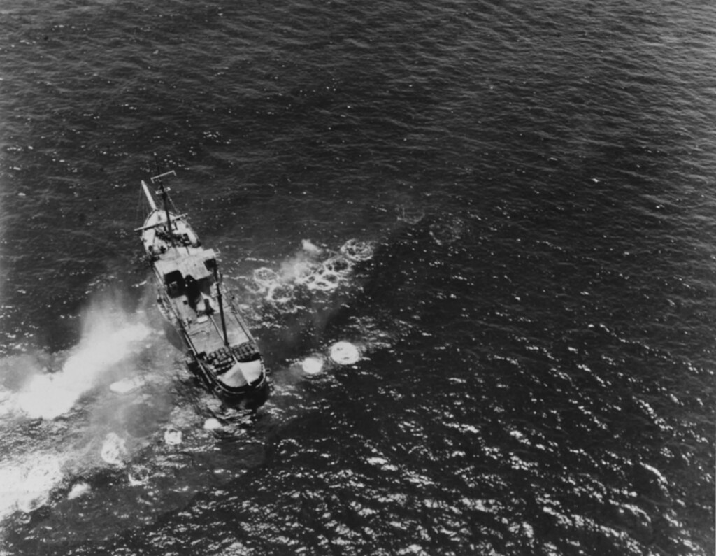 A Japanese Cargo Vessel being strafed by a PB4Y-1 bomber of USN bombing squadron 106 in the southwest Pacific in 1943-44.
