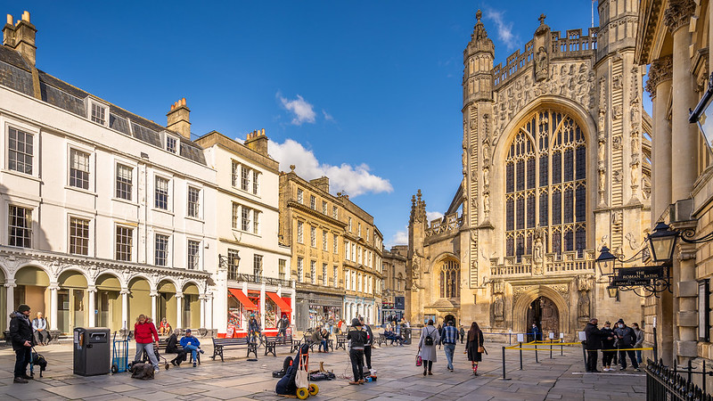 A wide shot of the square in front of Bath Abbey and the Pump Room and Roman Baths. 