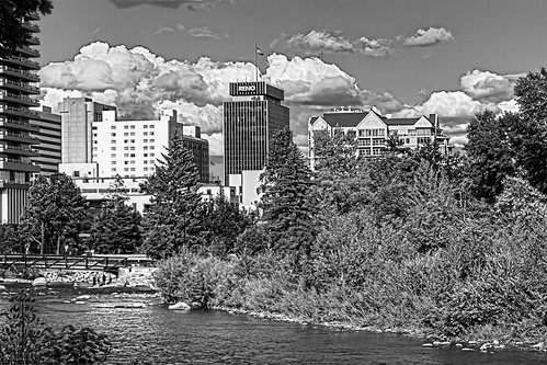 horizontal day outdoors outside reno nbv nevada hdr highdynamicrange photomatix blackandwhite bw grays tones trees truckeeriver river waterway reflections flag word letters flagpole people cumulusclouds highlights shadows