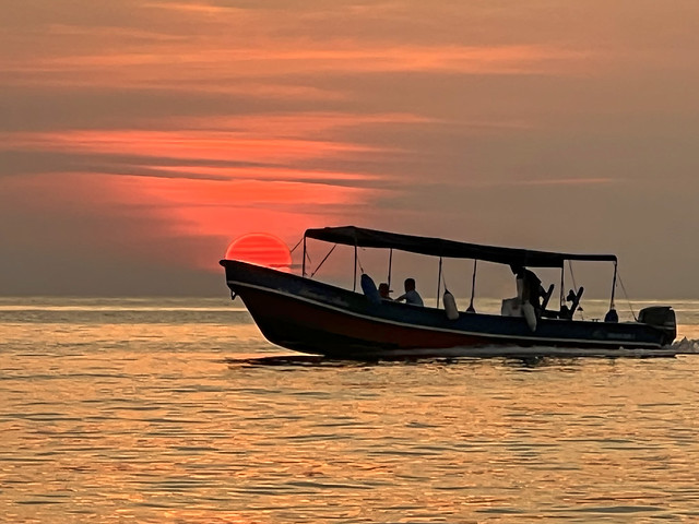 Sunset and the boat at Roatan, Honduras