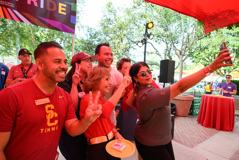 alumni pose with USC president Carol L. Folt