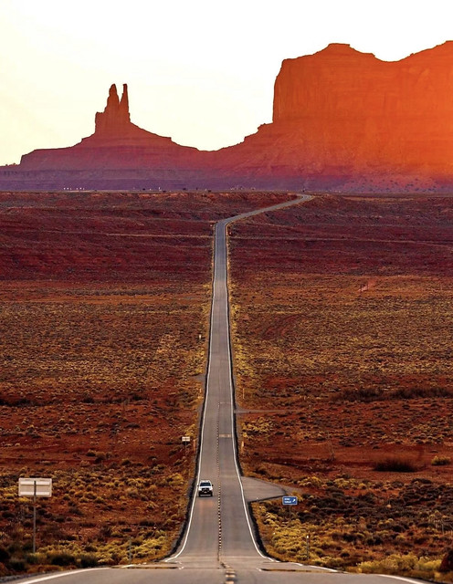 Monument Valley is an area of red sand desert on the border of Arizona and Utah, known for the towering sandstone hills of Monument Valley Navajo Tribal Park, and a frequent setting for movie shoots.