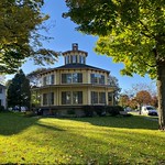 Rich-Twinn Octagon House, Akron, New York, October 2021 The Rich-Twinn Octagon House, 145 Main Street at Townsend Street, Akron, New York, October 2021. Popularized by Orson Squire Fowler&#039;s 1848 tome &lt;i&gt;A Home for All, or a New, Cheap, Convenient, and Superior Mode of Building&lt;/i&gt; which advocated the form due to its efficient use of space, octagon-shaped houses (usually paired with Italianate aesthetic elements) were a fairly popular feature of mid-19th century American architecture, yet the Rich-Twinn House is the only extant example in Erie County. Built in 1849, this was originally the home of Charles B. Rich (1808-1870), a prominent figure on the local business and political scene who lived there from its completion in 1849 until his death. Rich had the house designed by architect and contractor James Twinn for his wife, who had seen and admired several octagon houses during their honeymoon trip along the Erie Canal. In this example, each side of the house is sixteen feet in length; the main entrance is raised about six feet above ground level, with a half-basement below, the entire first floor is surrounded by an enormous wraparound porch, and the roof is surmounted by a handsome belvedere cupola with bracketed cornice in keeping with aforementioned Italianate principles. Interestingly, the kitchen was located in the basement, with food conveyed upwards from the large fireplace to the dining room by way of a dumbwaiter. The building has been owned by the Town of Newstead since 1981 which operates it as a local historical museum.