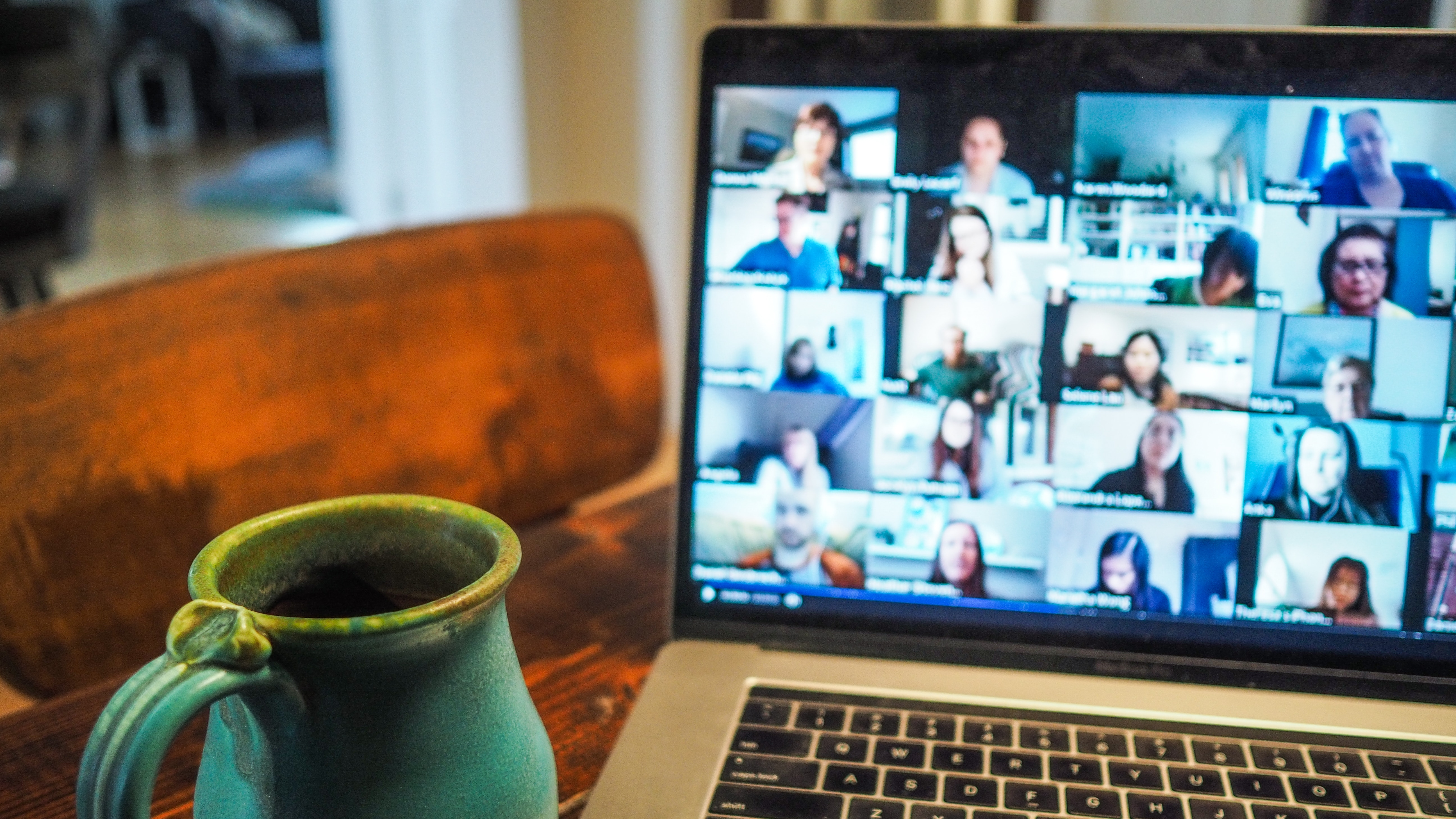 A laptop screen showing a group of people having an online meeting