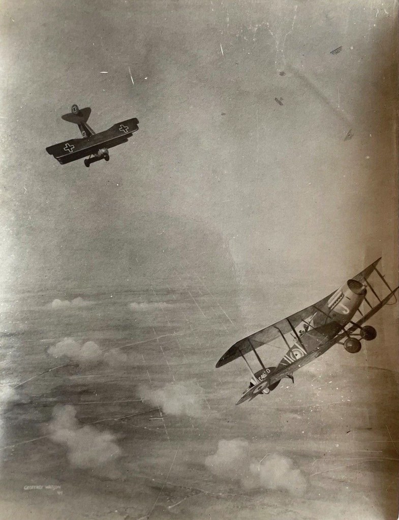 Photograph of painting by Geoffrey Watson - RAF Bristol Fighter and a German Tri Plane in combat - WW1